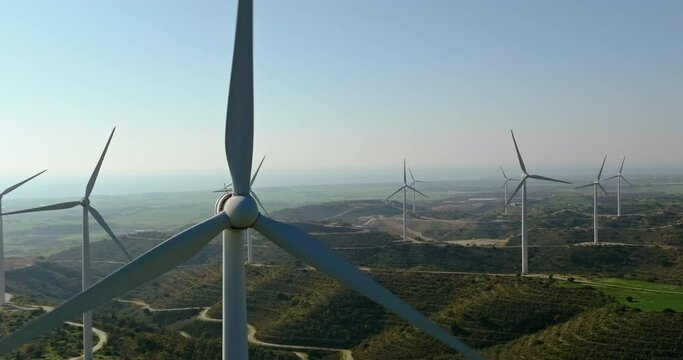 windmills that extract electricity from the force of the wind. Close-up of windmill blades in the mountains. A beautiful landscape and ecological production of electricity at the station. 