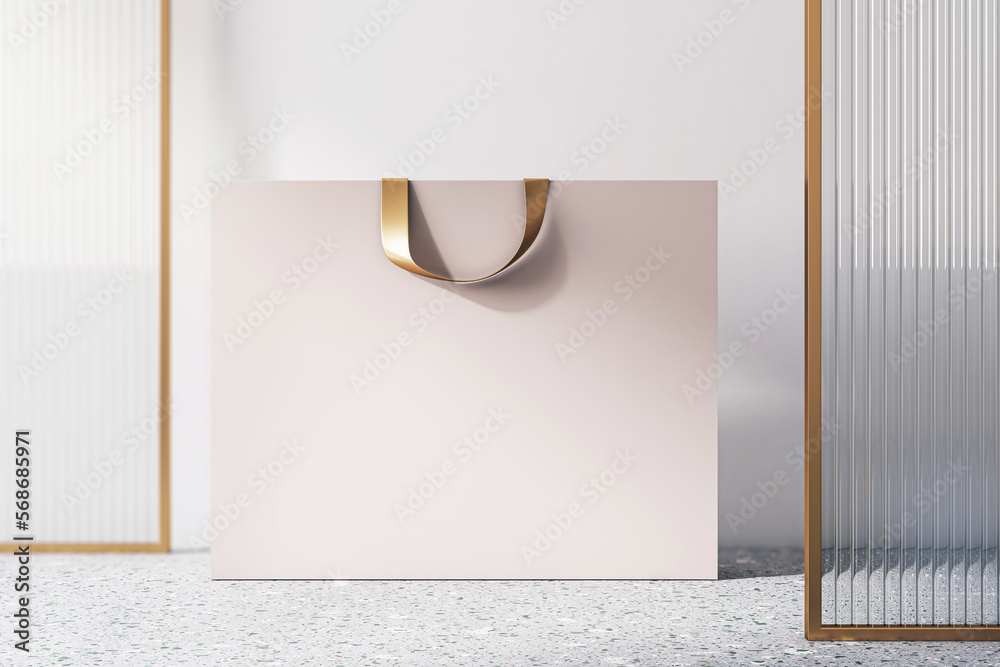 Poster Front view on blank beige paper shopping bag with golden braid and space for your brand name or text on concrete floor and light wall background, closeup. 3D rendering, mock up