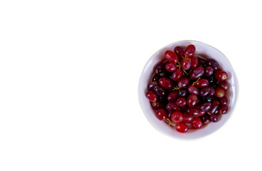 Red grape isolated on pink cup, white background