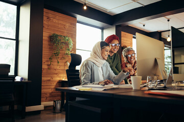 Cheerful businesswomen collaborating in a modern office