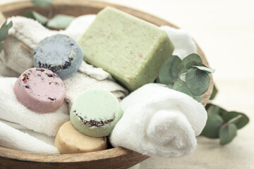 Obraz na płótnie Canvas Close-up, colored handmade soap, towel and eucalyptus.