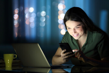 Woman checking phone in the night