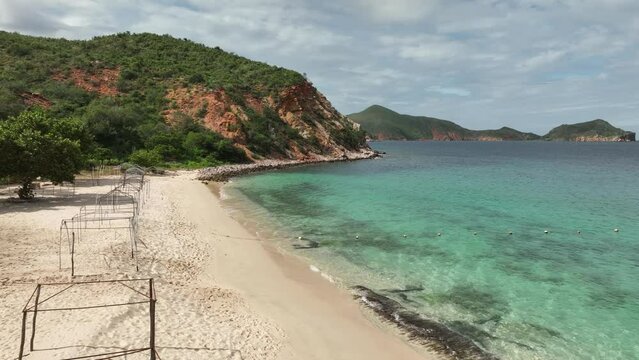 Camera along the empty Playa Blanca beach in Mochima National Park. Venezuela.