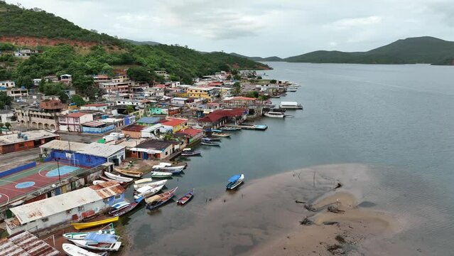 Camera slowly moving along the waterfront of small Venezuelan town Mochima in Mochima National Park, Venezuela.
