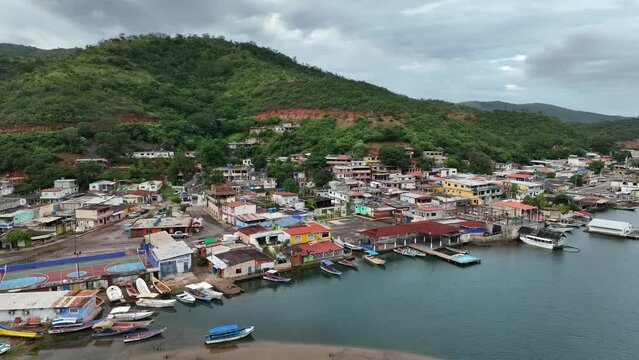 Aerial moving panoramic view of small Venezuelan town of Mochima in Mochima National Park, Venezuela.