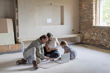 Mature man and woman calculating with calculator and discussing over documents