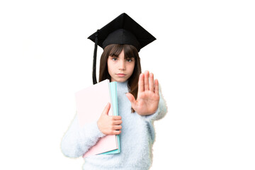 Little caucasian student girl over isolated background making stop gesture