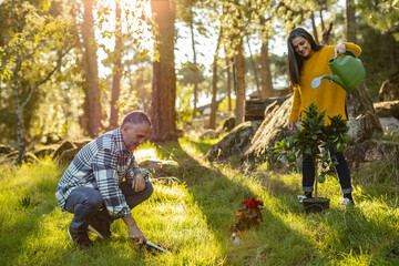 Mature couple caring for natural garden