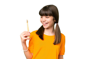 Little caucasian girl brushing teeth over isolated background with happy expression