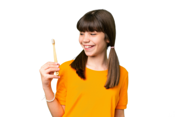 Little caucasian girl brushing teeth over isolated background with happy expression