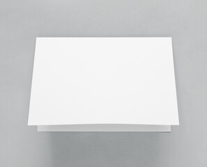 Blank paper folded on gray background