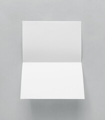 Blank paper folded on gray background