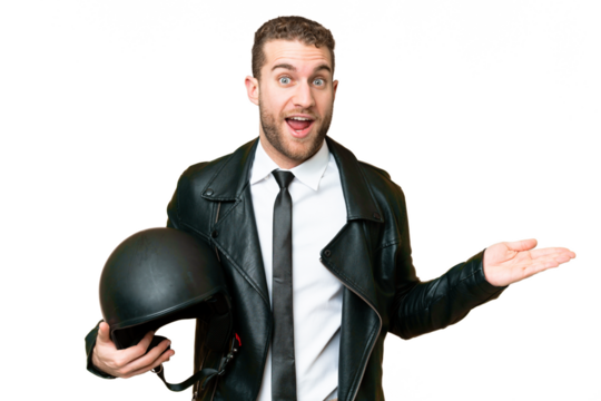 Business man with a motorcycle helmet over isolated chroma key background with shocked facial expression