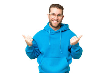 Young handsome blonde man over isolated chroma key background with thumbs up gesture and smiling