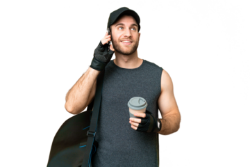Young sport man with sport bag over isolated chroma key background holding coffee to take away and a mobile
