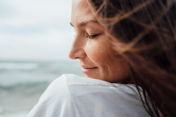 Close-up of smiling woman with eyes closed
