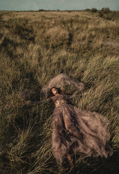 beautiful young girl dreams of lying on a magic meadow