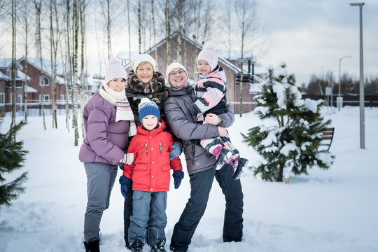 Portrait of happy family with grandmother at the winter village.