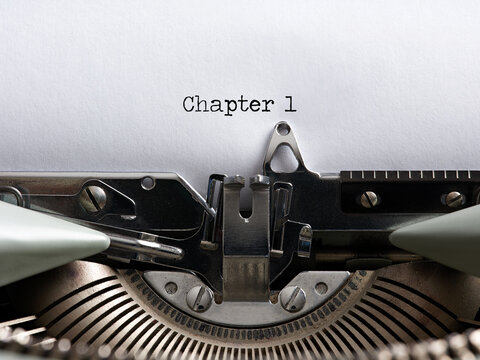 The word chapter 1 written with a vintage typewriter. Storytelling, book writing or authorship concept.