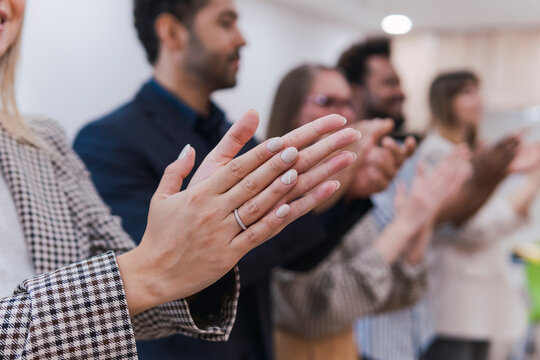 Business people clapping hands after a presentation in office
