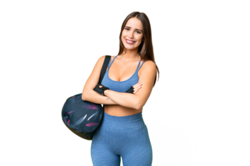 Young sport woman with sport bag over isolated chroma key background with arms crossed and looking forward