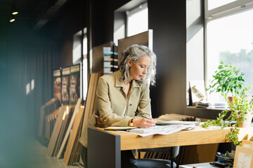 Female architect working at table in office