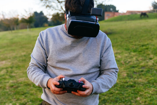 Man with virtual reality goggles and drone control controller