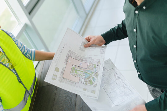 Businessman and engineer holding plan