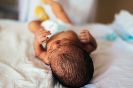 Newborn Baby Lying In A Hospital Bed.