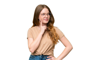 Young pretty woman over isolated background thinking an idea while looking up