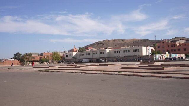 Arabic suburban square with people walking by