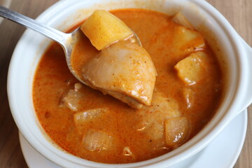 Homemade Thai Yellow Chicken Curry with Potato on white bowl. Halal food in Thailand. 
