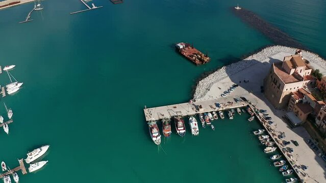 Aerial Birds Eye View Over Castellammare Del Golfo Port With Slow Right View Of Castello Arabo Normanno. Establishing Shot 