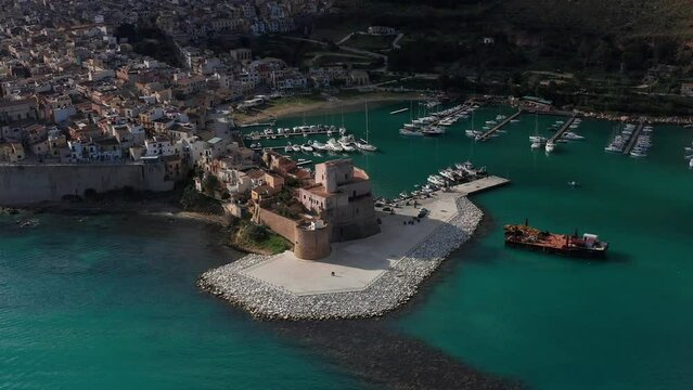 Aerial View Of Castello Arabo Normanno Located Beside Castellammare Del Golfo Port In Sicily. Dolly Back, Ascending Shot