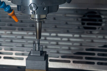 The CNC milling machine finish cutting the graphite electrode parts with solid ball end mill.