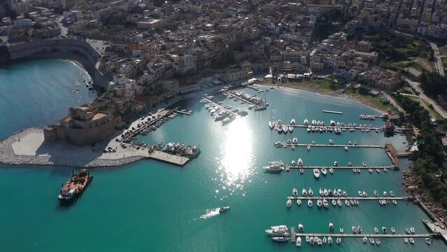 Aerial View Of Castellammare Del Golfo Port In Sicily With Castello Arabo Normanno On Sunny Day. Circle Dolly 