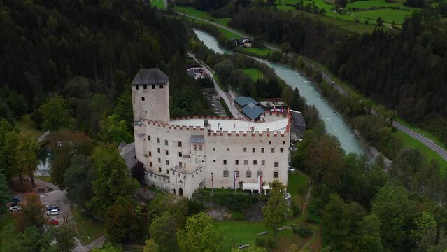 Aerial View Of Castle Bruck Beside River Isel In Austria. Parallax Shot 