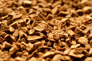 Background of instant coffee closeup, banner. Texture of instant coffee granules, top view. Instant coffee background, texture, top view. Texture of brown coffee granules, banner.