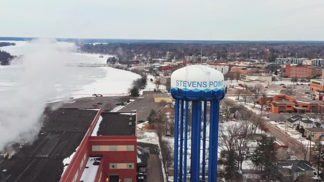 Aerial, water tower in Stevens Point Wisconsin during winter day