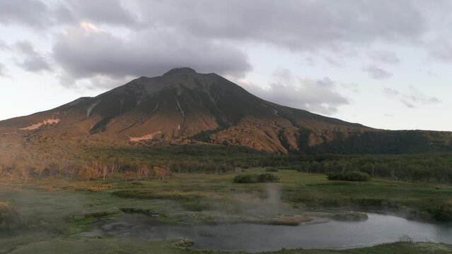 The volcano. The reflected in the thermal spring . Kamchatka Peninsula. Pacific Ocean. Russia.