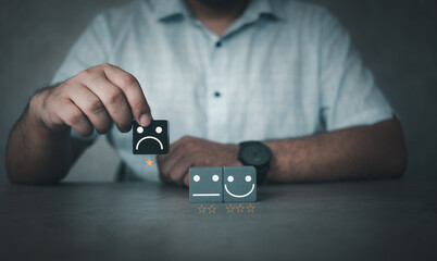Client choose sad face on wood cube block with 1 star. Feedback bad, bad service. Customer...