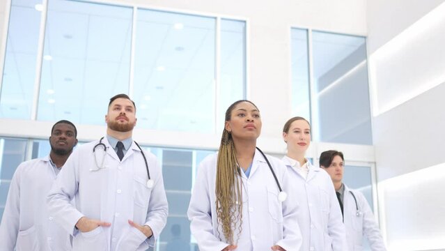 Group of doctors professional walking in hospital modern.