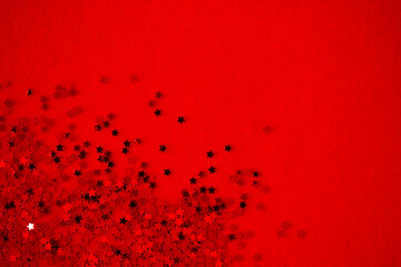 Shiny stars with a glossy shine on a red background. Flat style. Festive background.