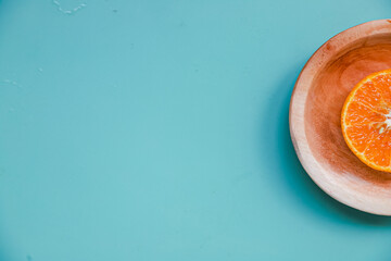 cut half of an orange on a blue table