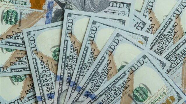 One hundred 100 dollars banknotes bills appearing, fanning out, disappearing on white background. Paper banknotes, cash, currency savings, finance bank, payment, salary, money, business. Flat lay.