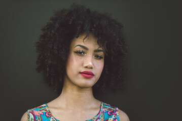 Beautiful afro-american girl with afro hairstyle and stylish clothing