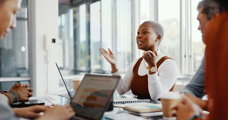 Meeting, discussion and professional black woman talking to her colleagues in the office conference room. Teamwork, presentation and African female employee in conversation with her team for project.