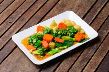 Fried stri mixed vegatable with oyster sauce on the white dish.