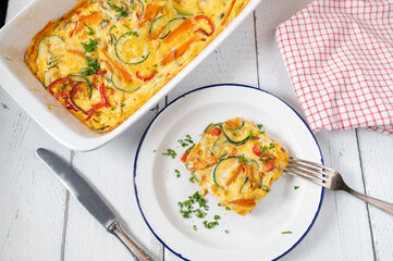 Frittata with mediterranean vegetables such as tomatoes, carrots, zucchini, onions, bell peppers...
