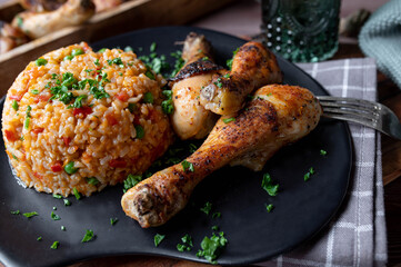 Chicken drumsticks with serbian djuvec rice on a plate